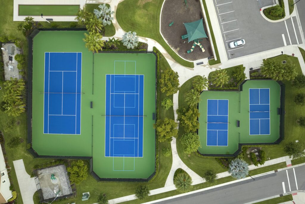 Aerial view of blue tennis courts for sports recreational activity